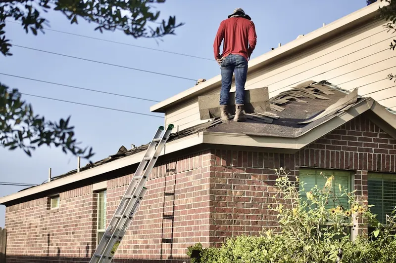 Professional roofer working on a residential roof in Garden Ranch